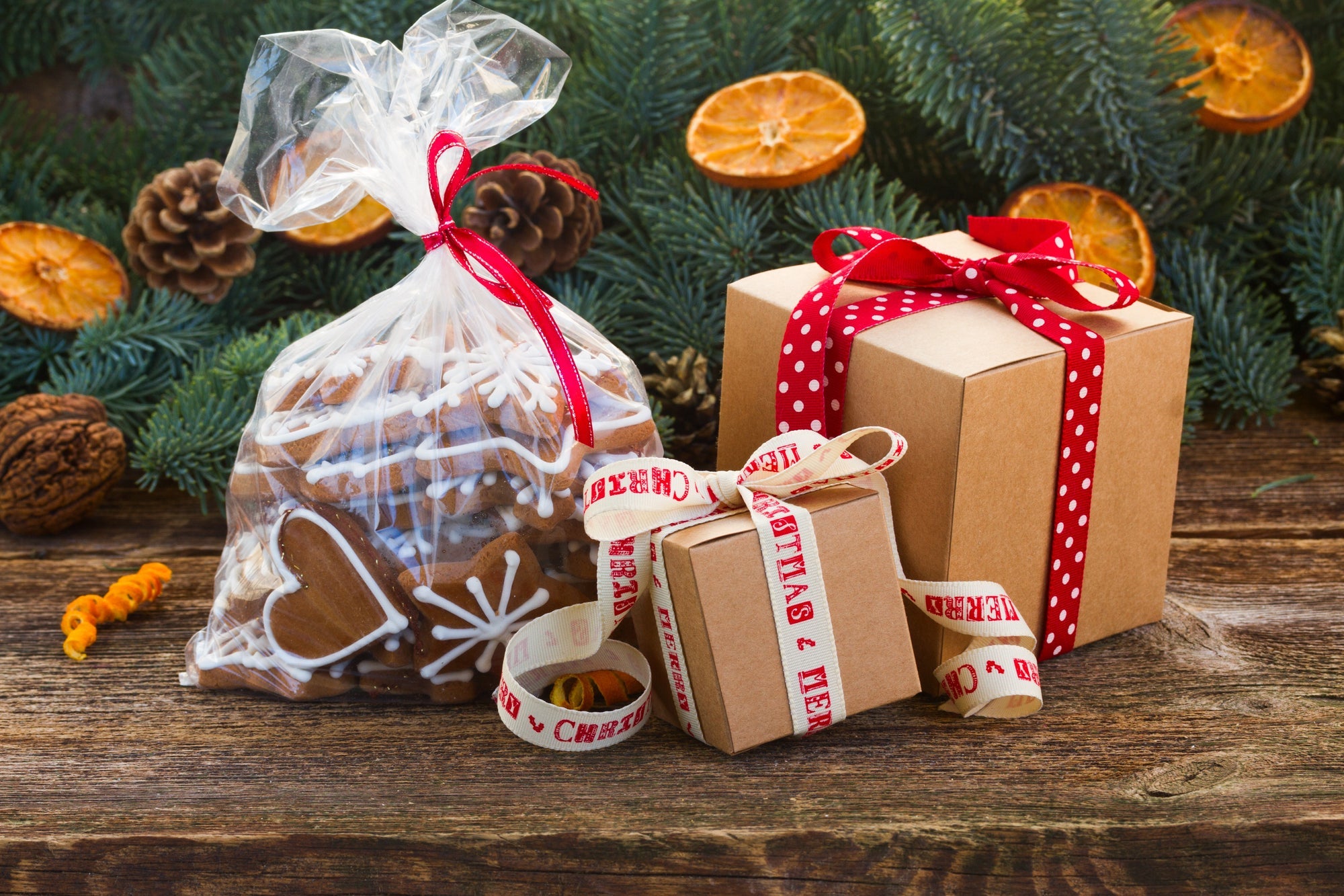 Christmas gift ideas with festive cookies and wrapped presents on rustic wooden table